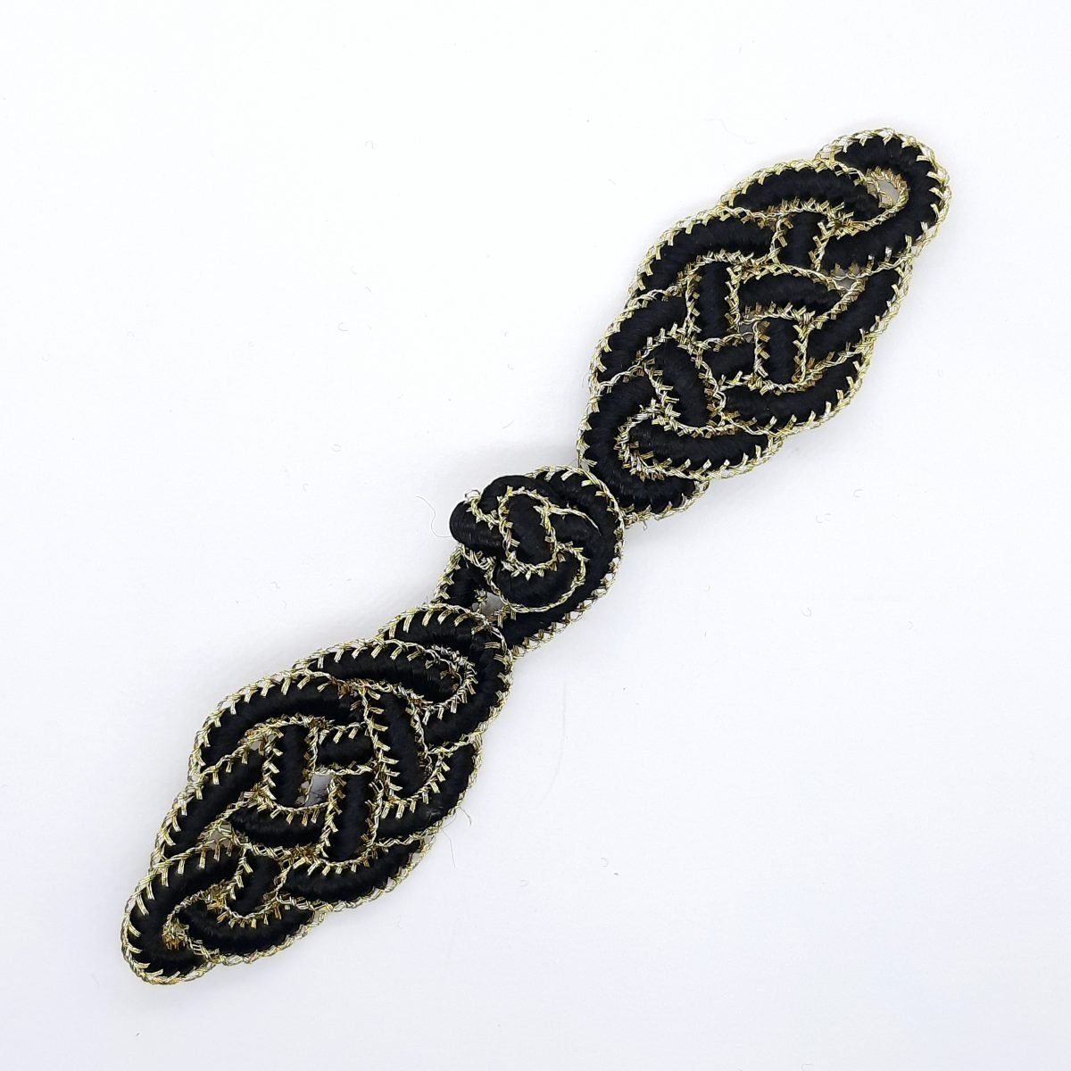 Broche pasamanería decorativo de color oro y negro